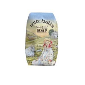 alt= bar of soap depicting a young girl in a filed with some sheep on a white background