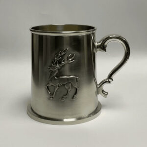 alt= sliver mug with raised pewter deer on a gray background