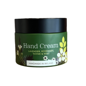 alt= green jar of hand cream with a black lid on a white background
