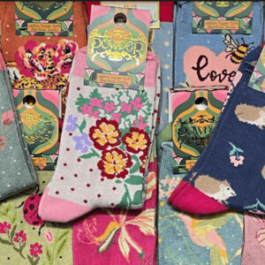 alt= collection of feminine colorful socks with a wide variety of styles pilled on top of each other