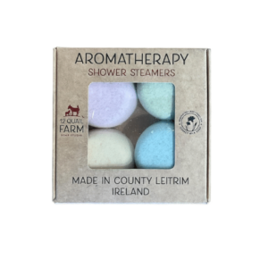 alt= tan box of pastel shower steamers on a white background