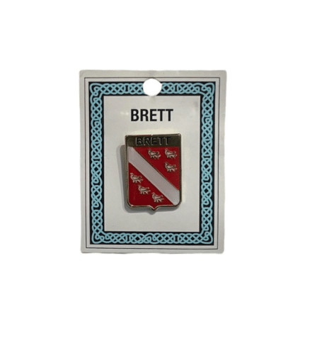 alt= a family crest pin depicting the Brett family crest