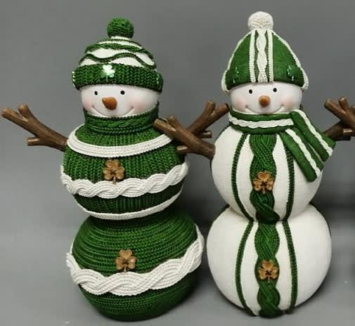 alt= a snowman figurine wearing green and sweater