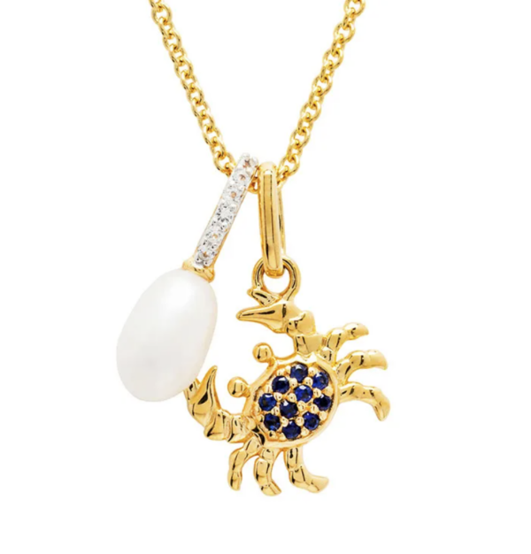 alt= a gold necklace with a golden crab with blue gems and a pearl on a white background