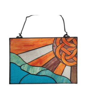 alt= a celtic inspired sunset stained glass window