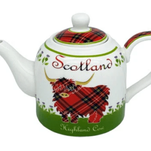 alt= a ceramic teapot with red tartan print accents with a stylized highland cow