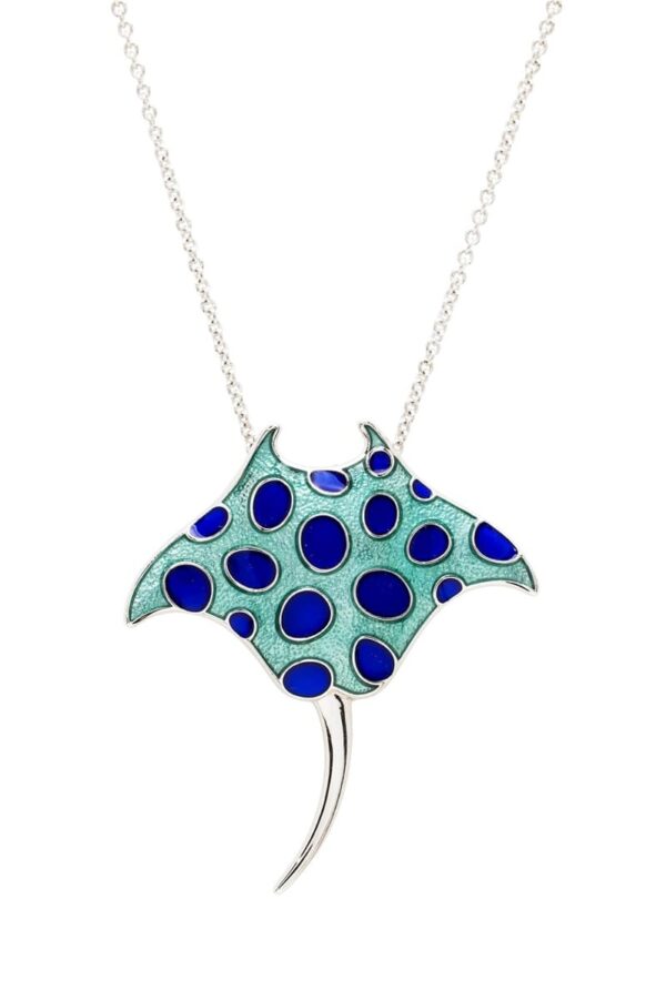 alt= sterling silver teal manta ray necklace with blue polkadots sits on white background