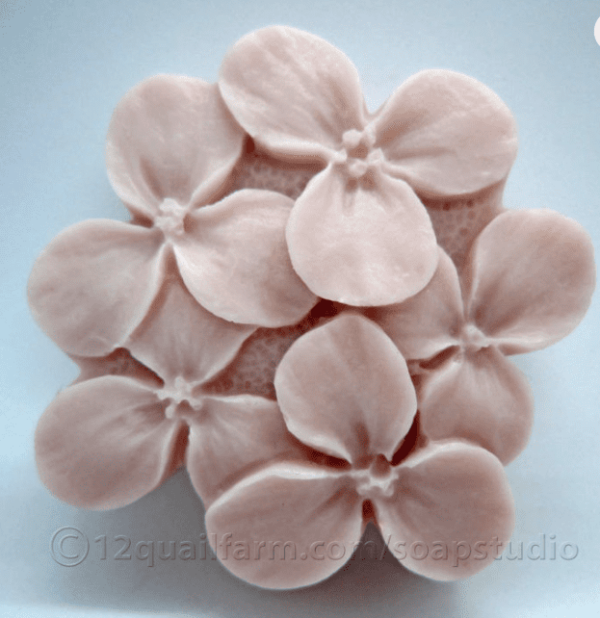 alt= bouquet of flowers made of pink soap sitting on a grey background