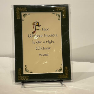 Irish Celtic decorative plaque with Claddagh and knotwork, featuring A Face Without Freckles phrase; crafted in rich green and gold tones.