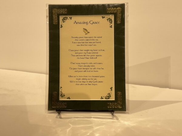 Framed Scottish Amazing Grace 5x7 poem on black stand, featuring Celtic knotwork in vibrant greens and golds against a beige backdrop.