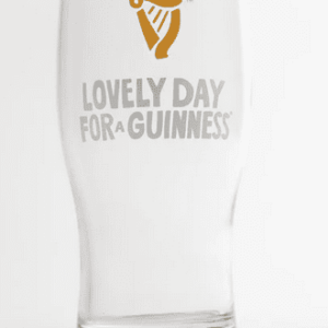 Irish pint glass features classic Guinness harp logo, Celtic script, clear glass craftsmanship—perfect for enjoying draught stout.