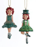 Two Irish dancer ornaments—red-haired girls in emerald dresses with Celtic knot trim, gold strings for festive hanging.