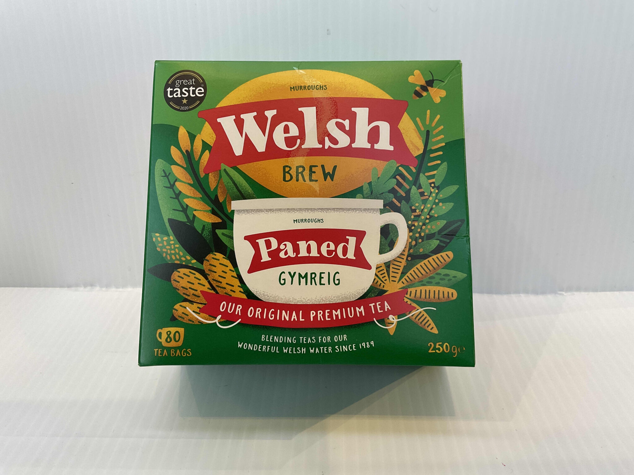 Welsh Brew tea box with Celtic knotwork, rich green hues, and “Paned Gymreig”; 80 authentic Welsh tea bags for daily brewing.