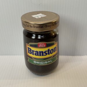A classic British Branston Pickle jar with gold lid, vibrant label, and rich chutney; beloved for sandwiches since 1922.