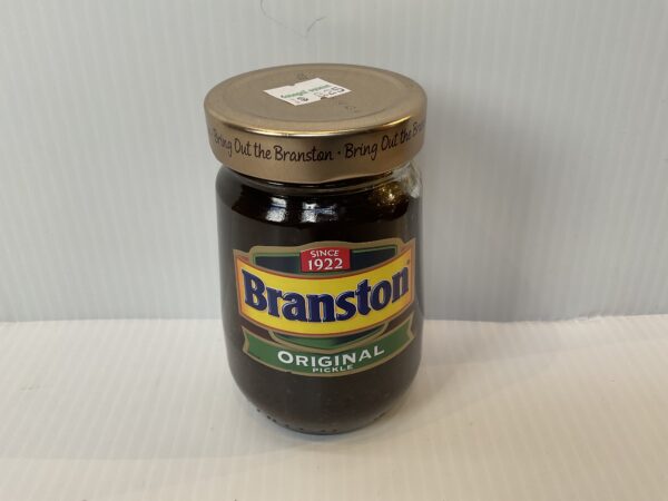 A classic British Branston Pickle jar with gold lid, vibrant label, and rich chutney; beloved for sandwiches since 1922.