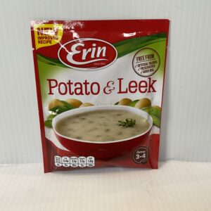 Irish Erin Potato Leek Soup in a vibrant red bowl, with fresh potatoes and leeks behind, evoking hearty Celtic tradition.