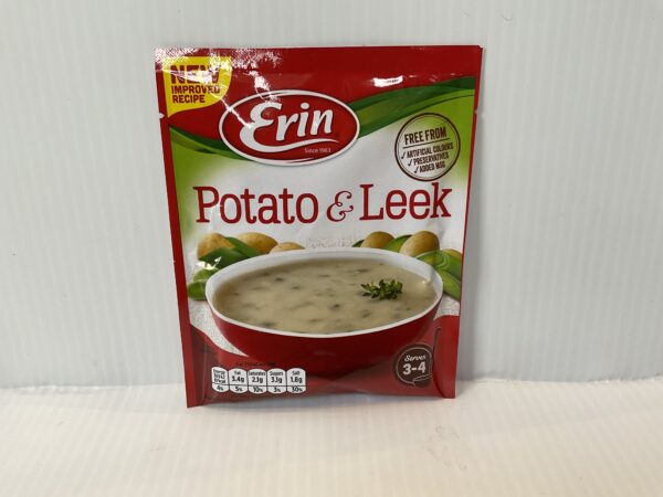Irish Erin Potato Leek Soup in a vibrant red bowl, with fresh potatoes and leeks behind, evoking hearty Celtic tradition.