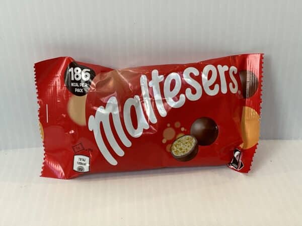 Maltesers Bag (37g) in vibrant red, English-made, with classic white script; iconic treat of crisp malted milk chocolate balls.