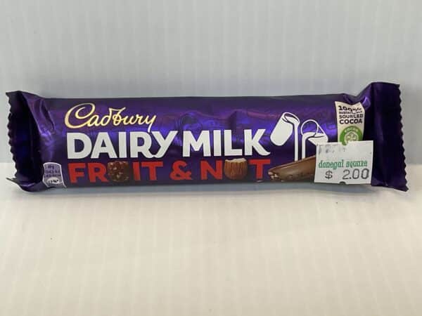 Certainly! Here’s an alt text revision based on your instructions: Irish Cadbury Fruit & Nut Bar, purple wrapper with gold Celtic knot, rich chocolate tradition, 49g snack with $2.00 label