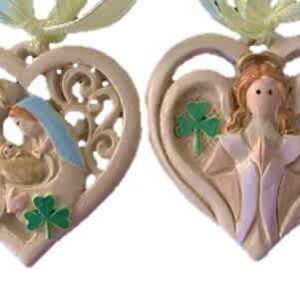 Irish heart-shaped ornament with Celtic knots, angel relief, vivid green shamrocks, gold ribbon; evokes Irish heritage charm.