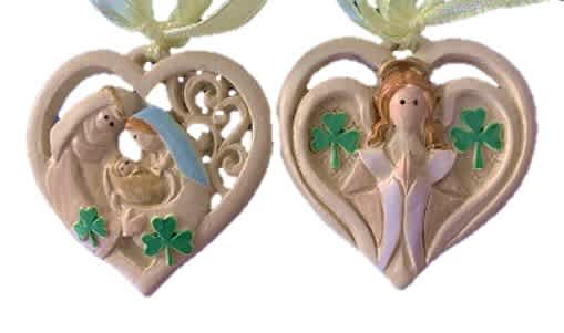 Irish heart-shaped ornament with Celtic knots, angel relief, vivid green shamrocks, gold ribbon; evokes Irish heritage charm.