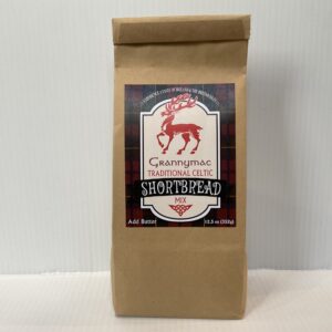 Scottish shortbread mix in a kraft bag with red tartan and stag, echoing Highland heritage and traditional festive baking.