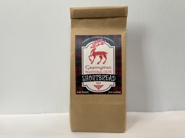 Scottish shortbread mix in a kraft bag with red tartan and stag, echoing Highland heritage and traditional festive baking.