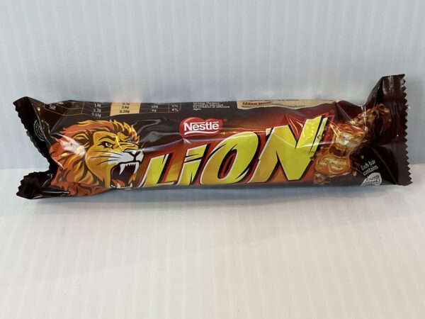 Irish-made 50g Nestlé Lion Bar in bold gold wrapper, featuring a roaring lion—symbol of strength in Celtic lore; classic snack.
