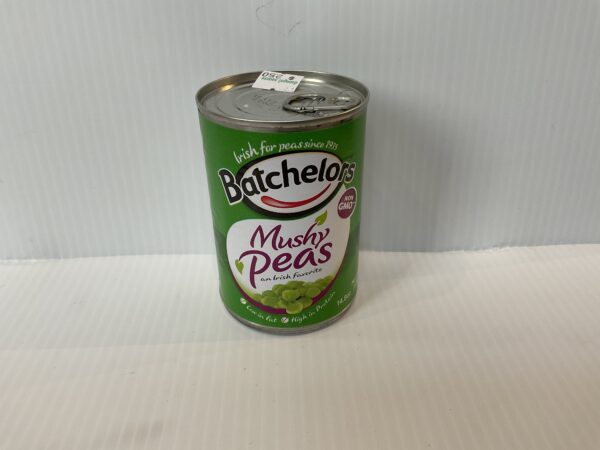 A classic British Batchelors Mushy Peas tin with rich green Celtic-inspired label, echoing UK comfort food tradition.